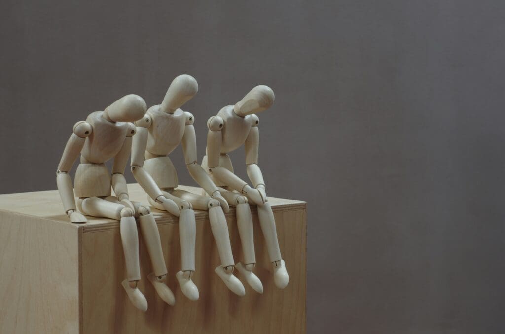 a group of wooden figurines sitting on a wooden surface
