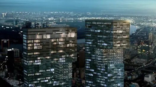 a two tall buildings with lights on them