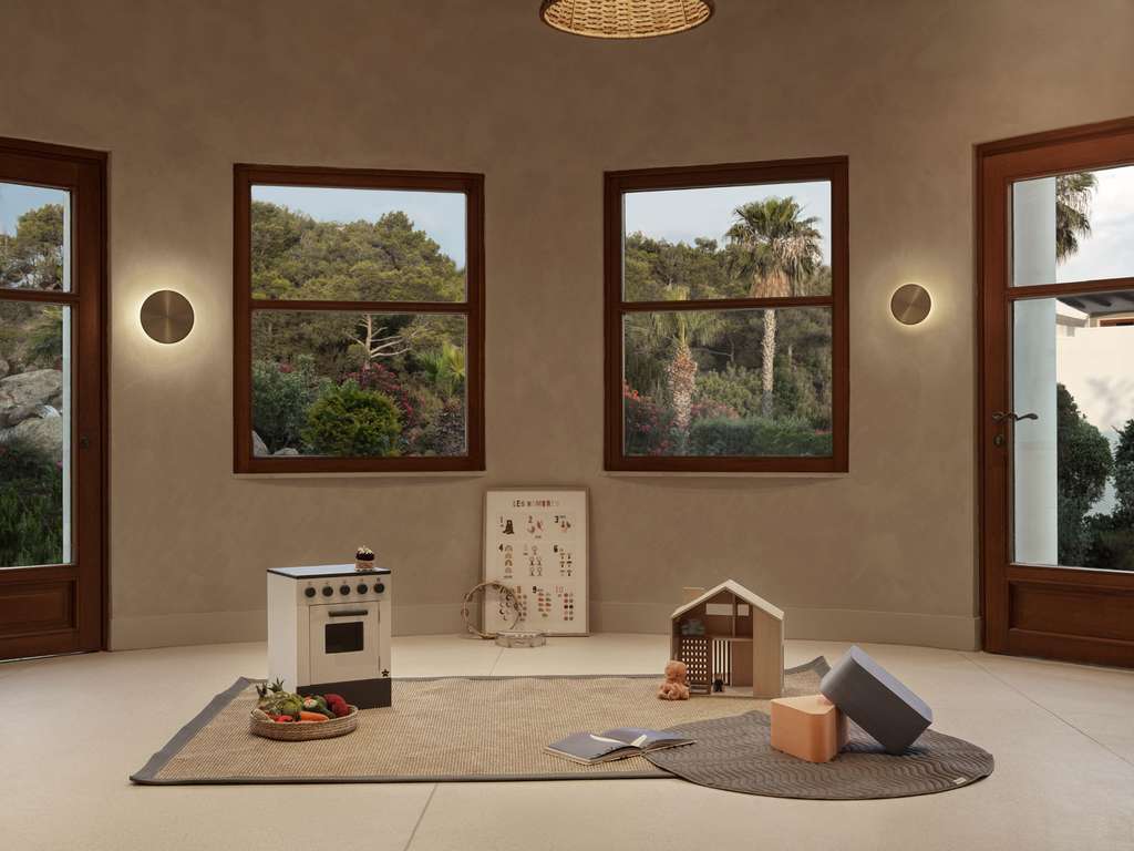 a room with a toy stove and toys on a rug