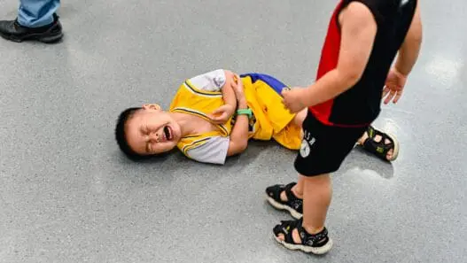 a boy crying on the ground