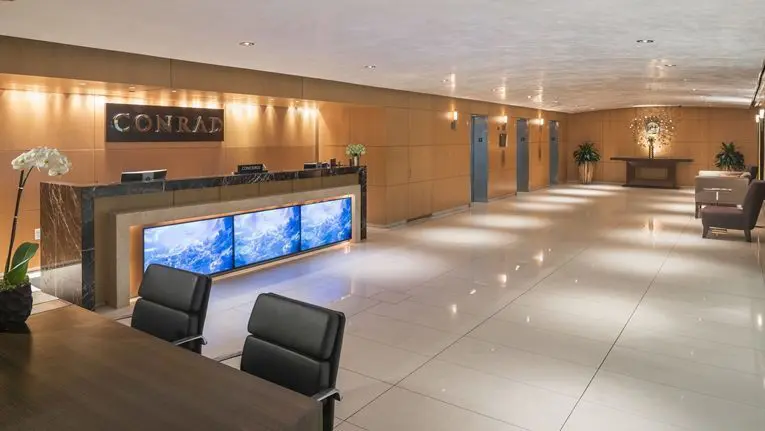 a long hall with chairs and a desk