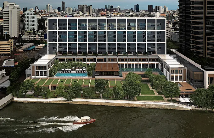 a building with a body of water and a boat