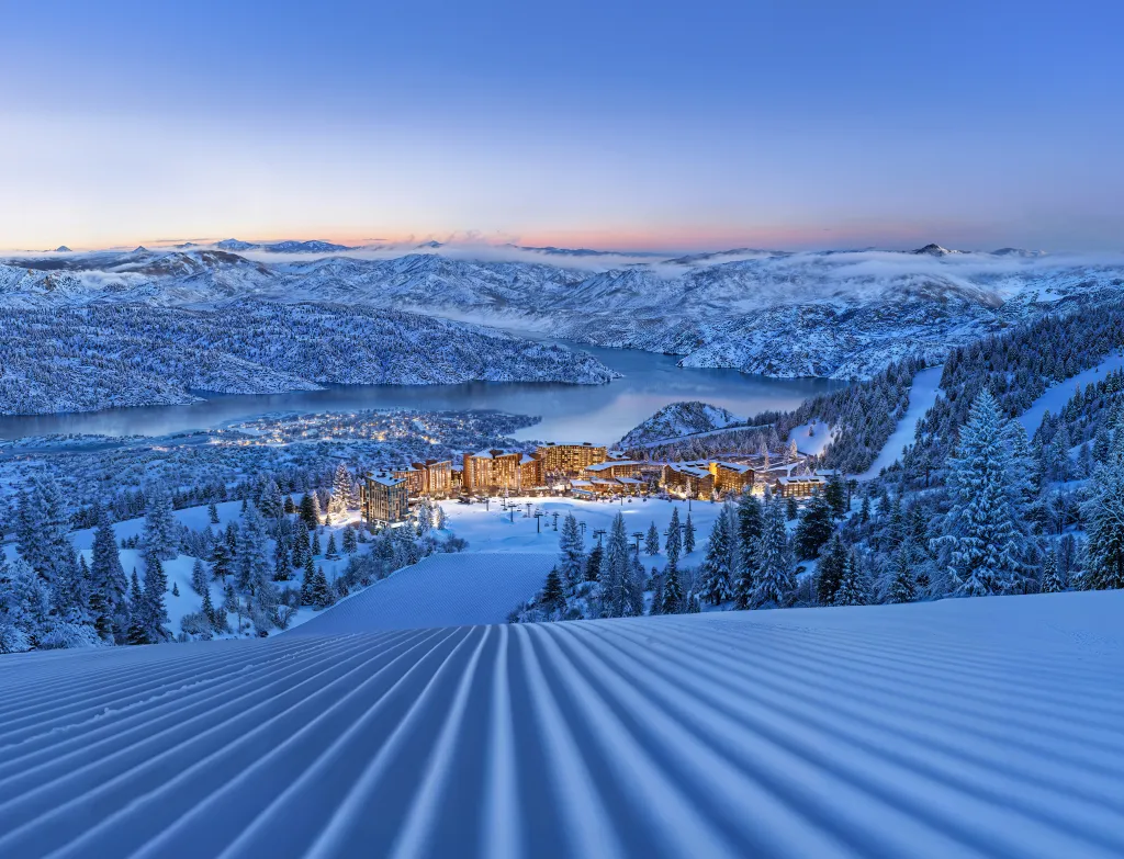 a snowy landscape with a building and a lake
