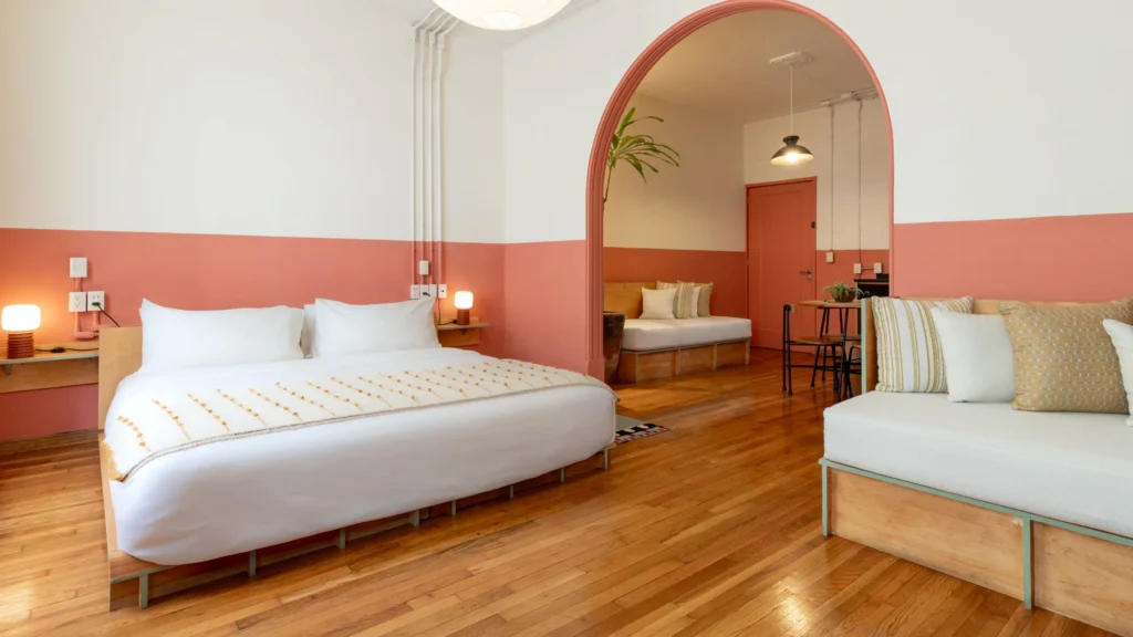 a room with a bed and a wood floor