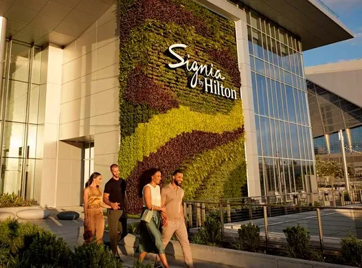 a group of people walking in front of a building