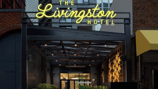 a hotel entrance with a sign