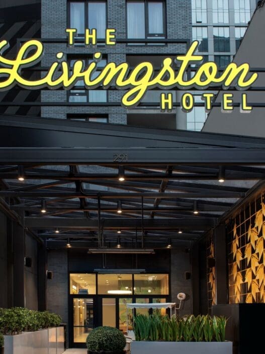 a hotel entrance with a sign