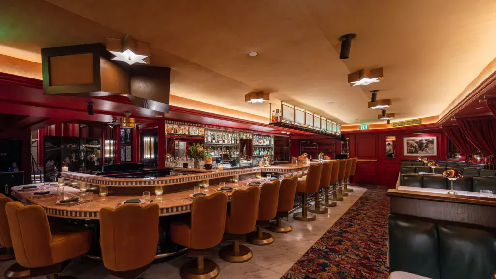 a bar with chairs and lights