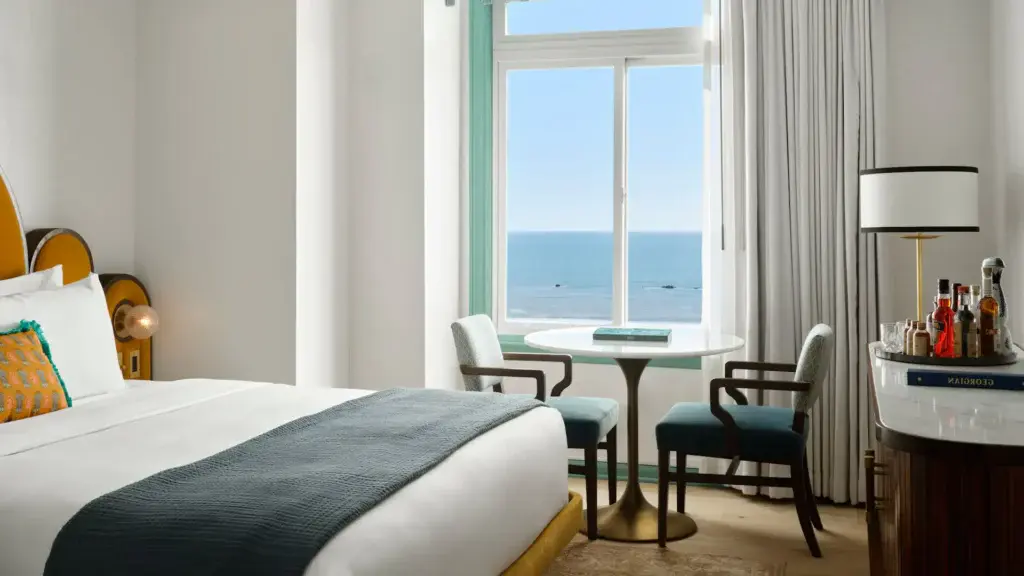 a room with a table and chairs and a window