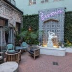 a patio with a statue and chairs