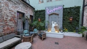 a patio with a statue and chairs