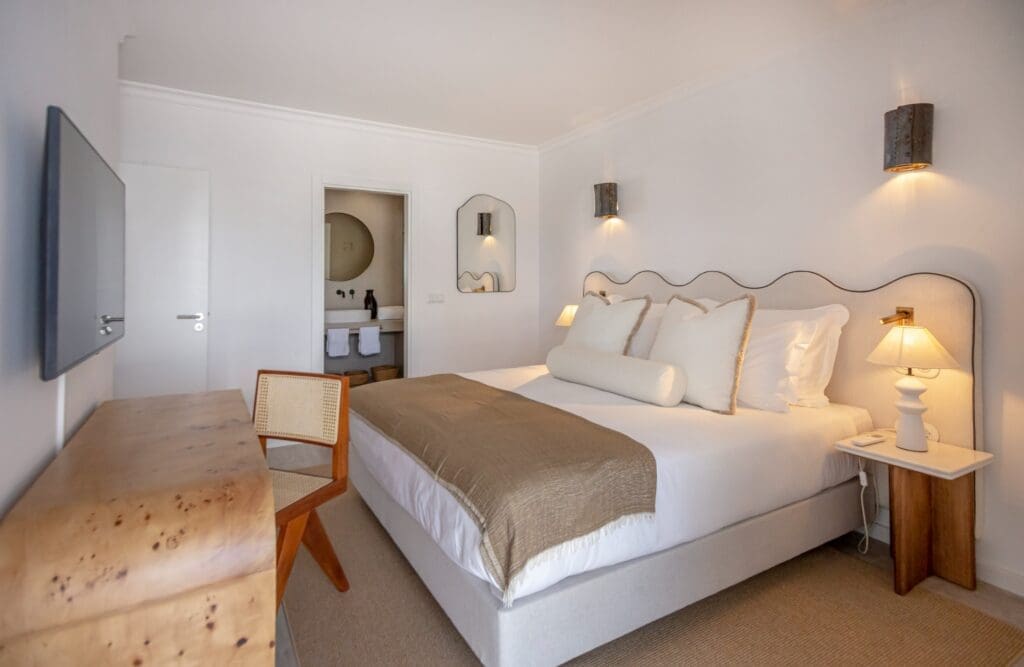 a bedroom with a bed and a desk