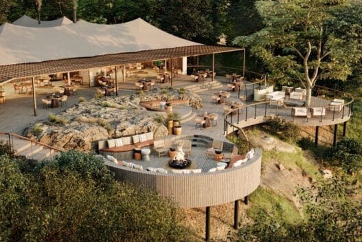 a large outdoor restaurant with a large tent and a large fire pit