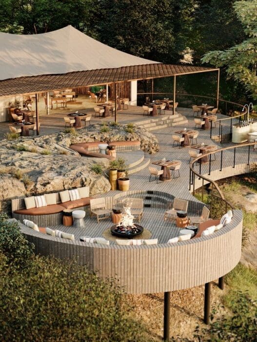 a large outdoor restaurant with a large tent and a large fire pit