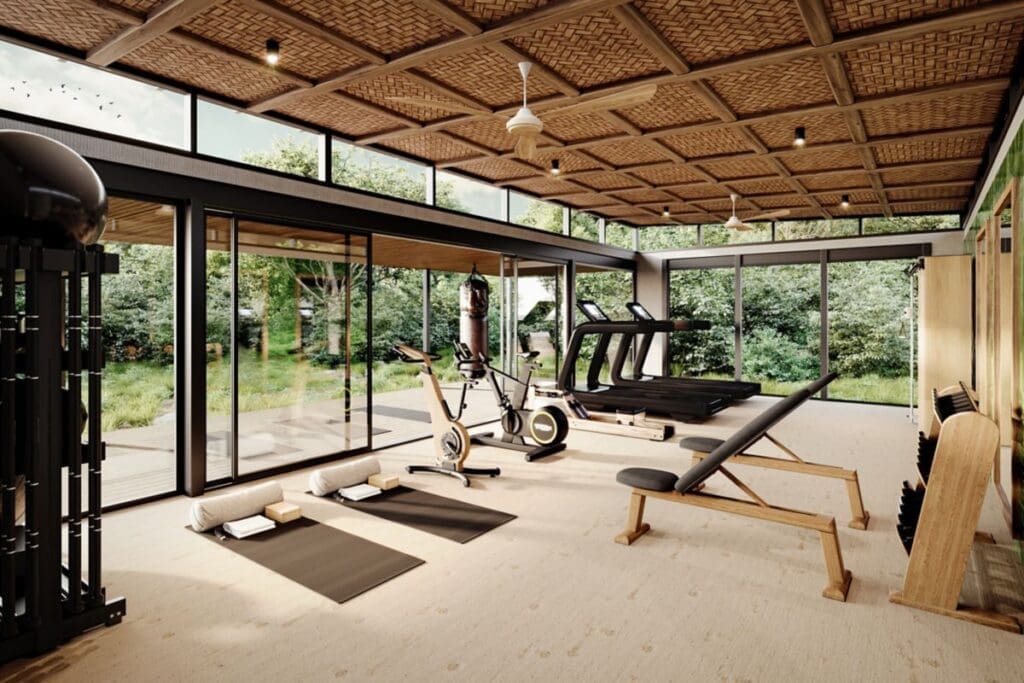 a room with exercise equipment and a glass wall
