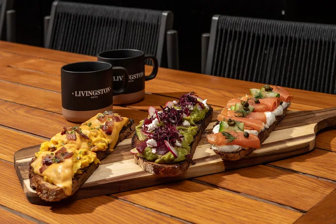 a group of sandwiches on a wooden board