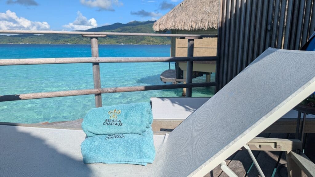 a beach chair with towels on a deck