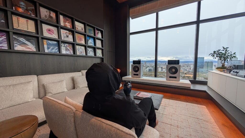 a person sitting on a couch looking out a window