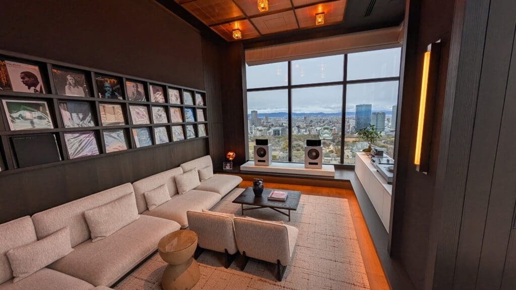 a room with a large window and a couch and a coffee table