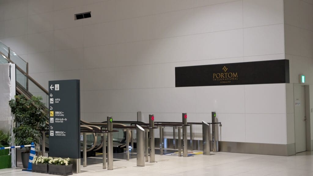 a gated entryway with a sign