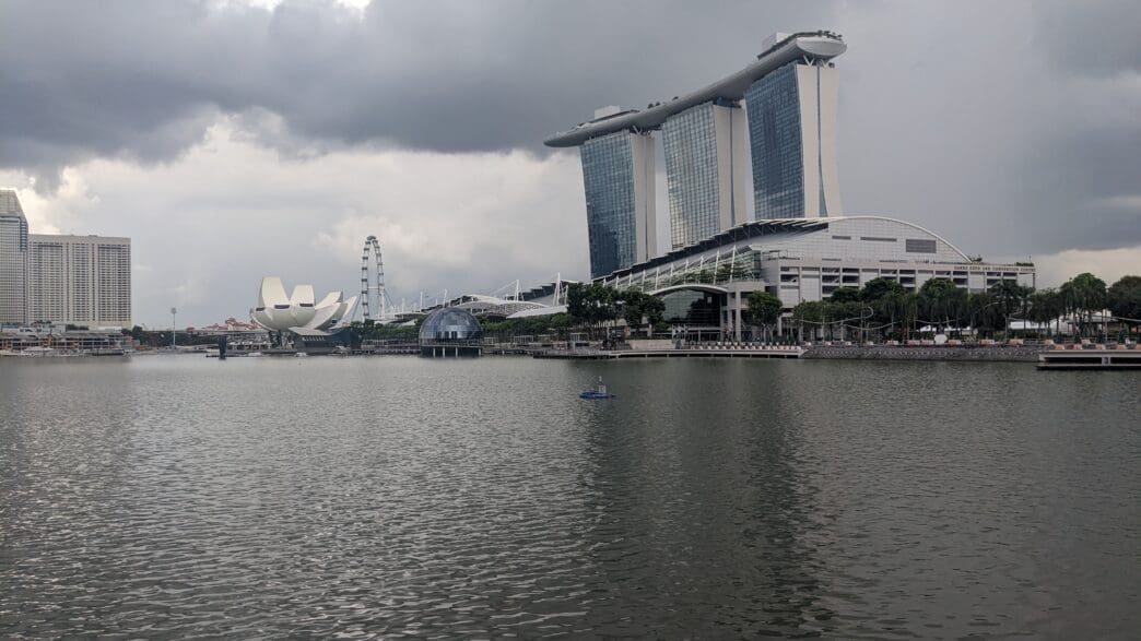 a body of water with buildings and trees