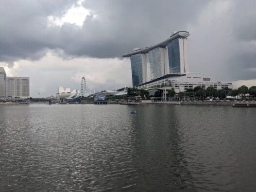 a body of water with buildings and trees