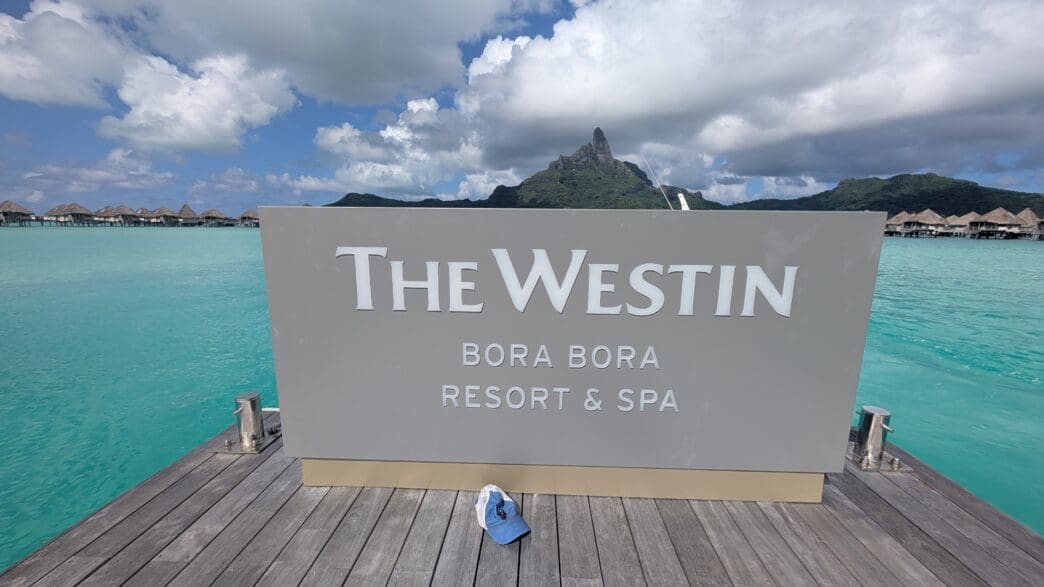 a sign on a dock with a blue hat on it