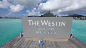 a sign on a dock with a blue hat on it
