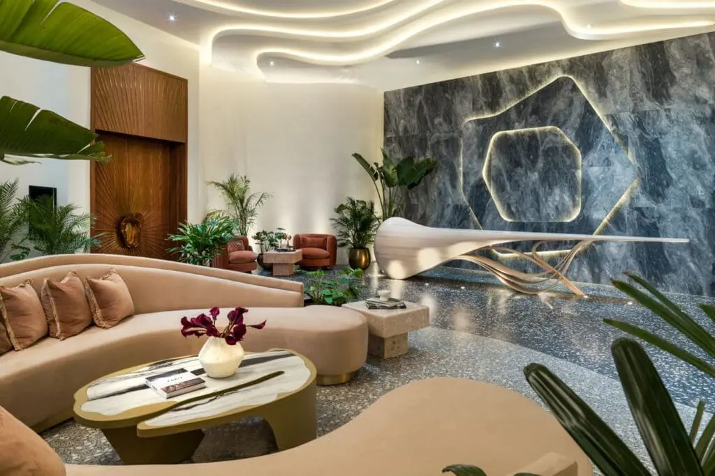 a room with a marble wall and couches