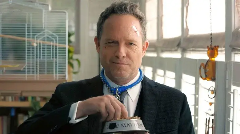 a man in a suit and tie eating from a bowl