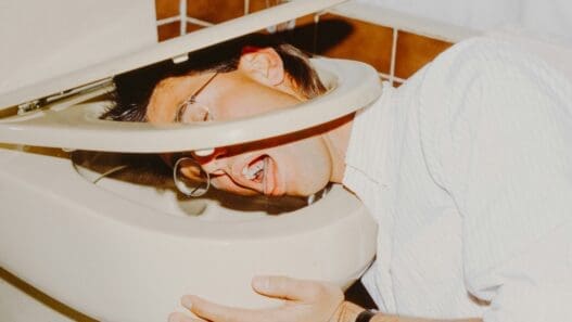 a man with his head in a toilet