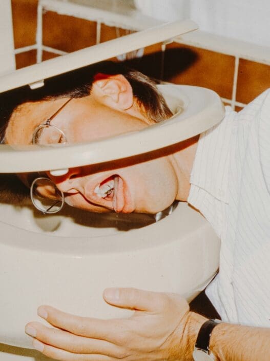 a man with his head in a toilet