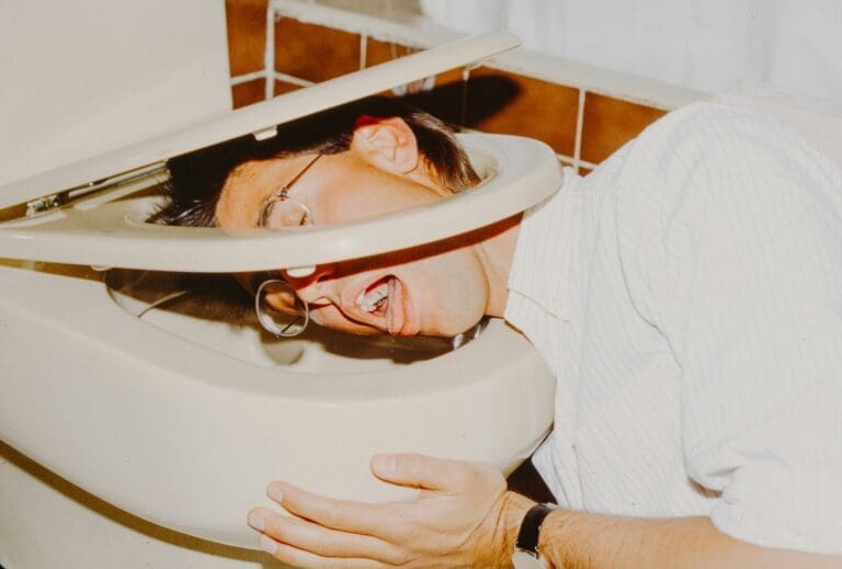 a man with his head in a toilet