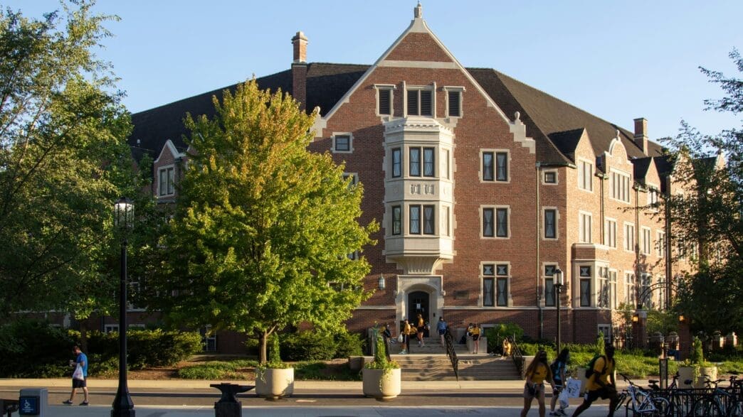 a group of people walking in front of a building