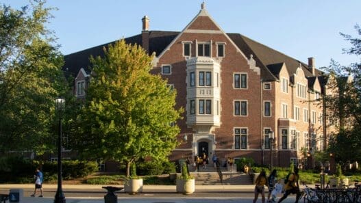 a group of people walking in front of a building