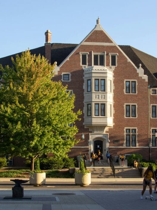 a group of people walking in front of a building