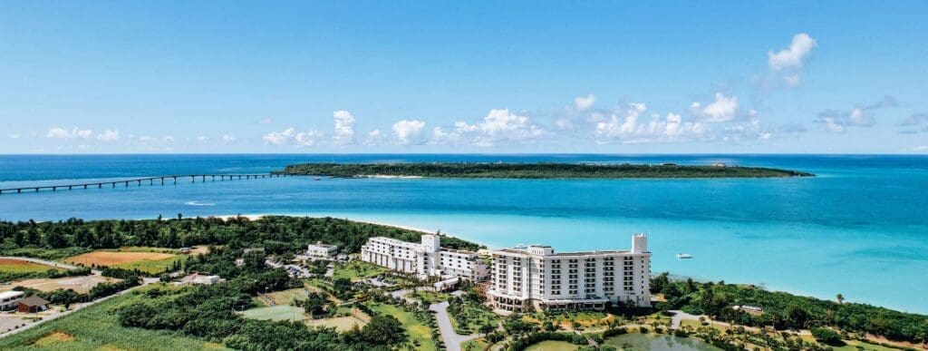 a large white building next to a body of water