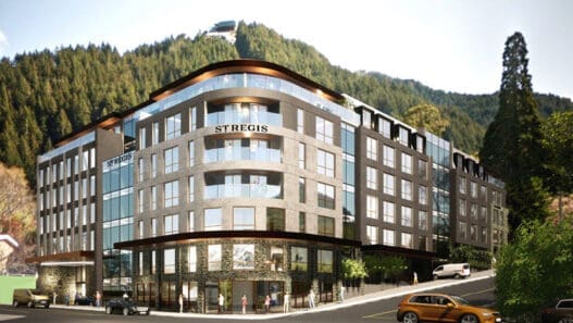 a building with a parking lot and cars parked in front of it