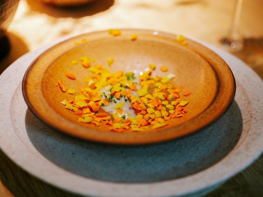 a plate with orange and yellow petals on it